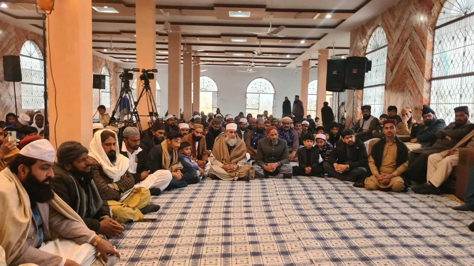 Congregation in prayer at BKM Community, Manchester