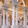 The white marble colonnade and arches of a mosque courtyard