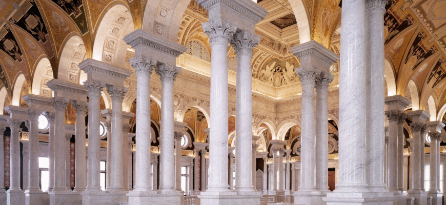 The white marble colonnade and arches of a mosque courtyard
