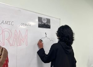 Teacher writing on a whiteboard during a class at BKM Community