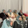 Women seated together in a circle during a community study session at BKM Community, Manchester
