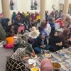 Community members sharing a meal together at BKM Community