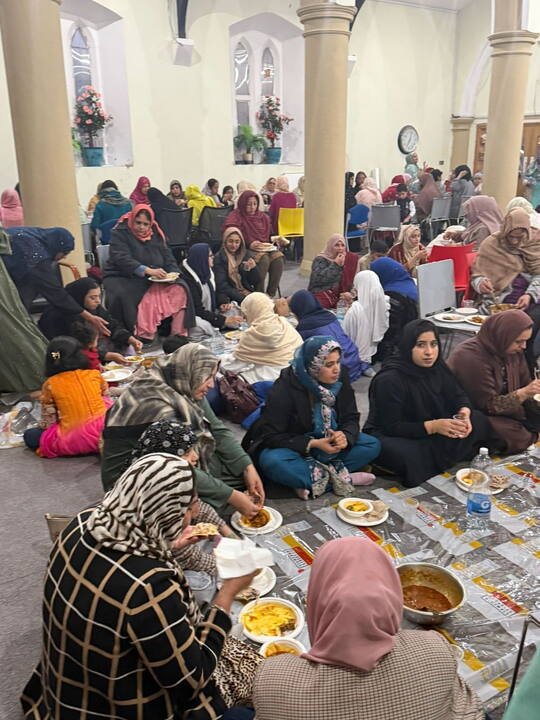 Community members sharing a meal together at BKM Community