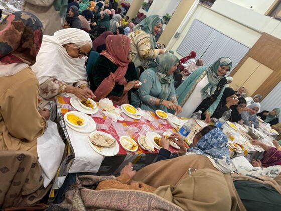 Community members sharing a meal together at a BKM Community gathering in Manchester